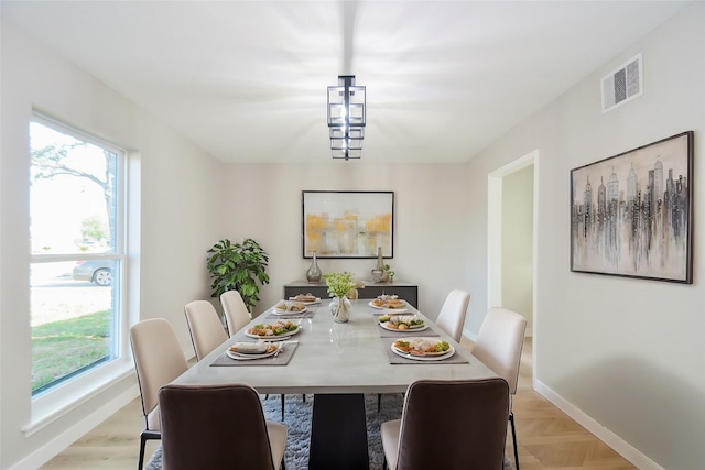 dining space featuring baseboards and visible vents