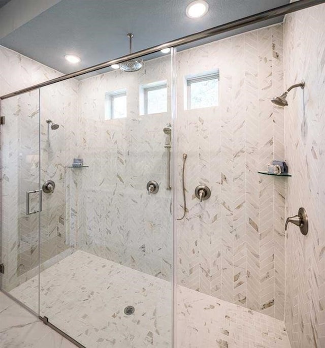 bathroom featuring a stall shower and marble finish floor