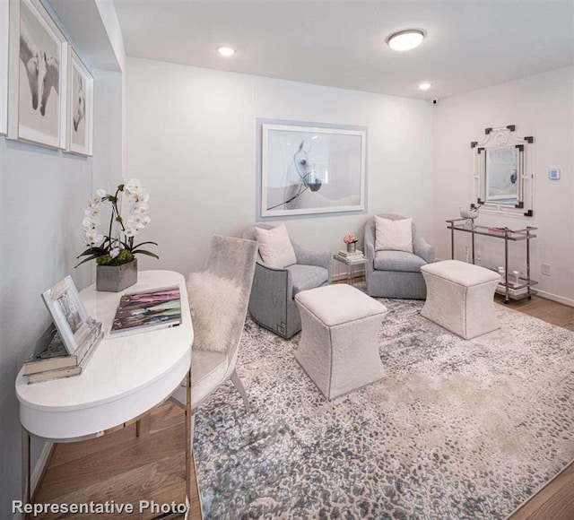 living room featuring baseboards, wood finished floors, and recessed lighting