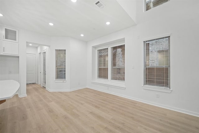 spare room with baseboards, visible vents, recessed lighting, and light wood-style floors