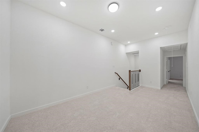 unfurnished room with recessed lighting, visible vents, baseboards, light carpet, and attic access