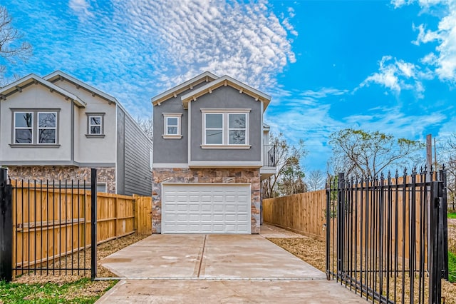 view of front of house with stone siding, stucco siding, driveway, an attached garage, and fence