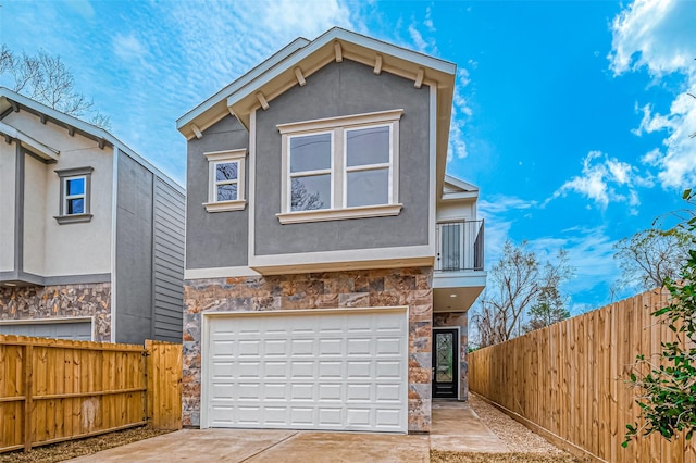 9418 Madera Rd, Houston, TX 77078 - view of front of home featuring stone siding, a garage, driveway, a balcony, and stucco siding