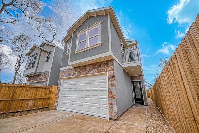 9418 Madera Rd, Houston, TX 77078 - view of front of home featuring a balcony, stone siding, a garage, and concrete driveway
