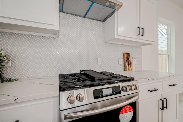9418 Madera Rd, Houston, TX 77078 - kitchen featuring gas stove, exhaust hood, backsplash, and white cabinetry