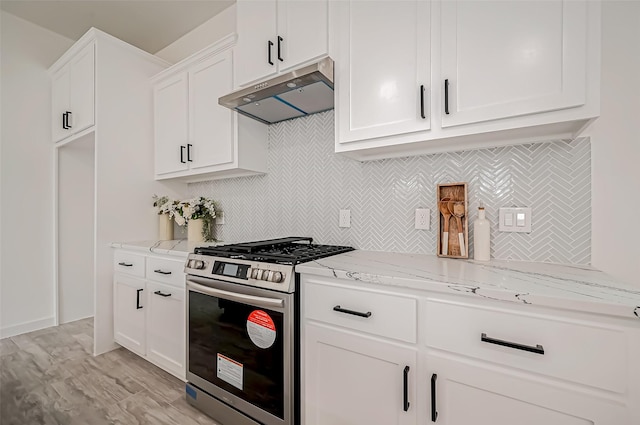 9418 Madera Rd, Houston, TX 77078 - kitchen featuring gas range, under cabinet range hood, light stone counters, backsplash, and white cabinets