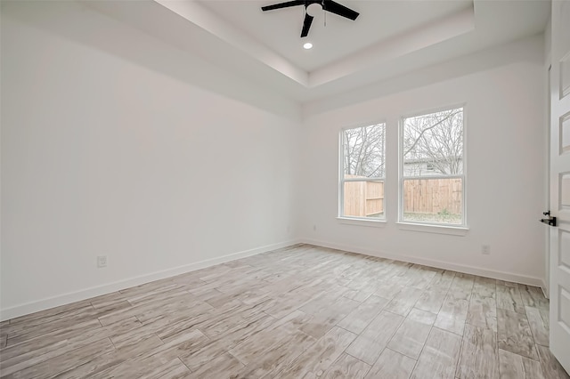 9418 Madera Rd, Houston, TX 77078 - spare room featuring ceiling fan, light wood-style flooring, a raised ceiling, baseboards, and recessed lighting