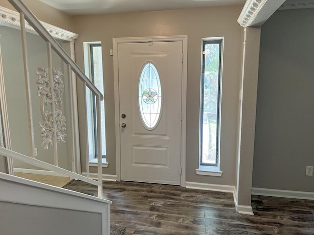 entrance foyer with baseboards, plenty of natural light, stairway, and dark wood-style flooring