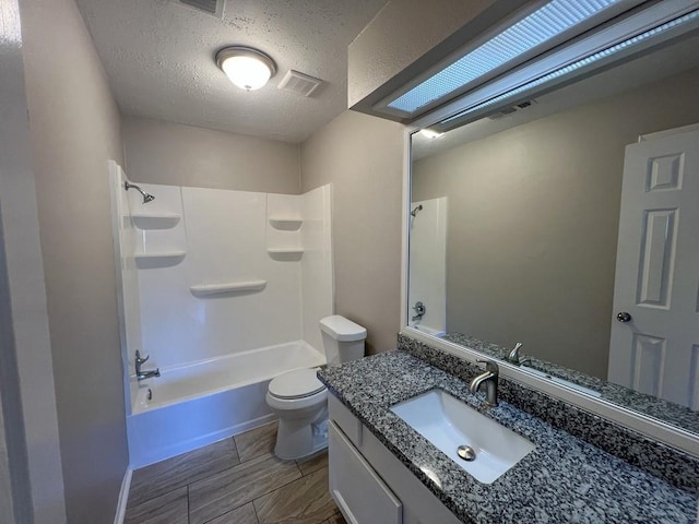 full bathroom with visible vents, toilet, tub / shower combination, a textured ceiling, and vanity