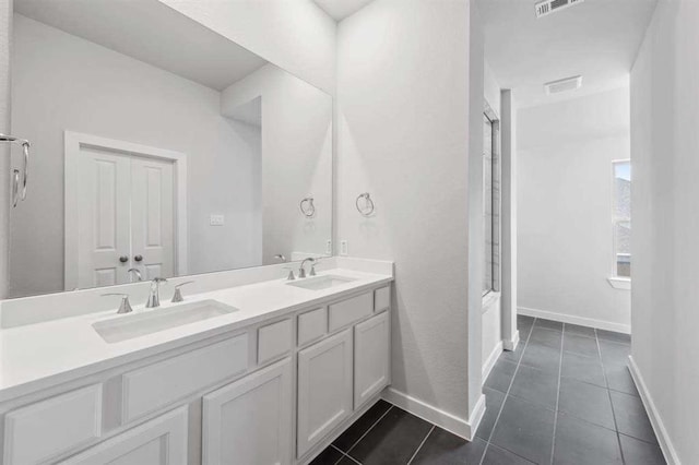 2666 Woodforest Pkwy N, Montgomery, TX 77316 - bathroom with tile patterned floors, double vanity, baseboards, and a sink