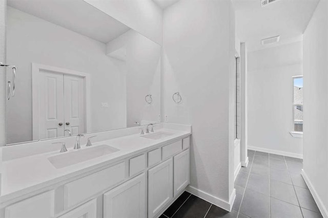 2666 Woodforest Pkwy N, Montgomery, TX 77316 - full bath featuring tile patterned flooring, double vanity, baseboards, and a sink