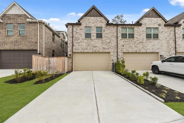 2666 Woodforest Pkwy N, Montgomery, TX 77316 - view of front facade featuring brick siding, board and batten siding, fence, driveway, and an attached garage