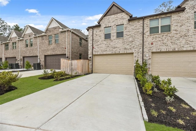 2666 Woodforest Pkwy N, Montgomery, TX 77316 - multi unit property with board and batten siding, concrete driveway, central AC unit, and a garage