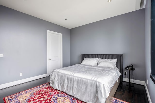 bedroom featuring baseboards and dark wood finished floors