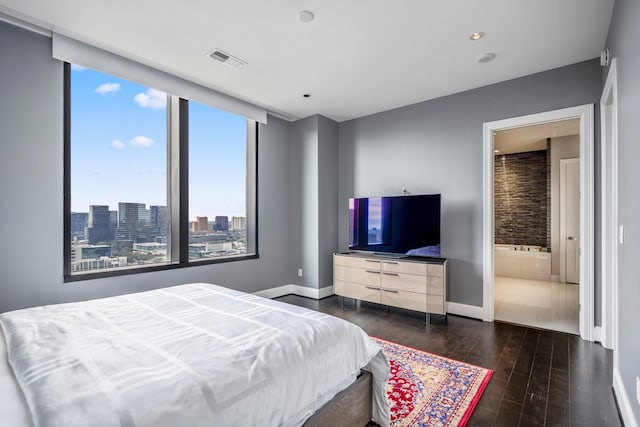 bedroom featuring dark wood-style flooring, visible vents, and baseboards