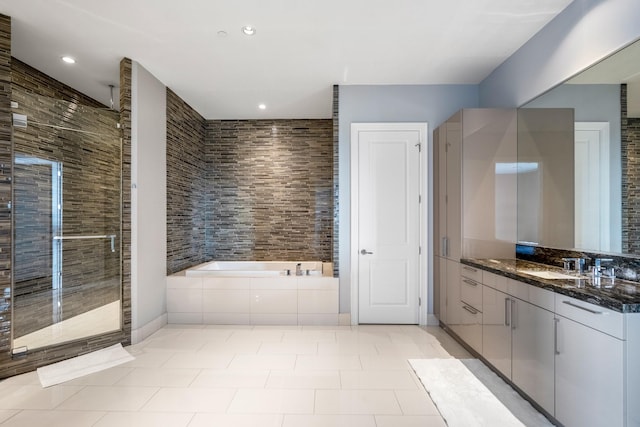 bathroom with a stall shower, vanity, recessed lighting, a bath, and tile patterned flooring