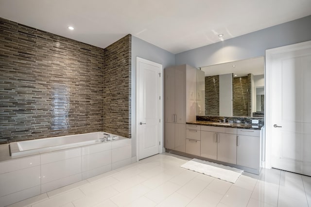 full bathroom featuring vanity, recessed lighting, decorative backsplash, tile patterned floors, and a garden tub