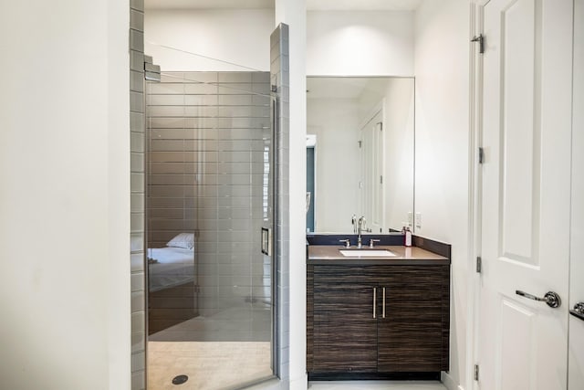 bathroom featuring a shower stall and vanity