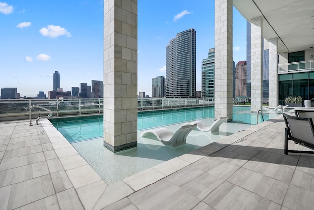 community pool featuring a patio area and a city view