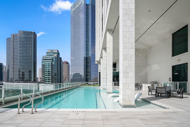 pool featuring a view of city and a patio