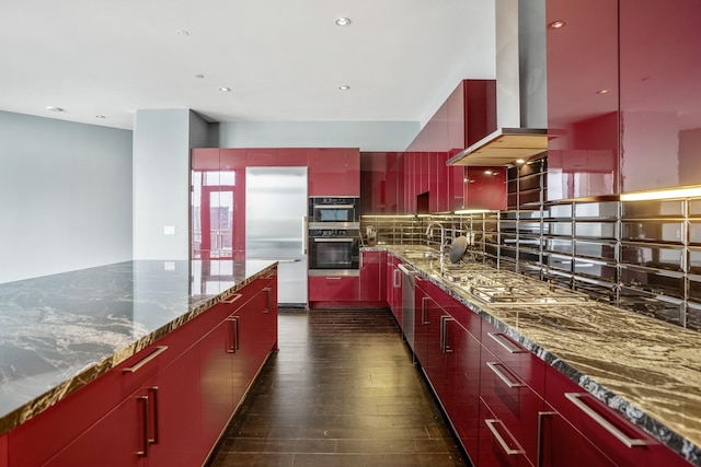 kitchen with modern cabinets, red cabinetry, appliances with stainless steel finishes, island range hood, and dark wood-style flooring