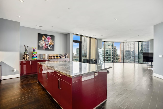 kitchen featuring dark wood-type flooring, open floor plan, modern cabinets, and a large island