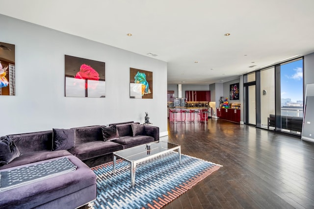 living area with recessed lighting, dark wood-style floors, and floor to ceiling windows