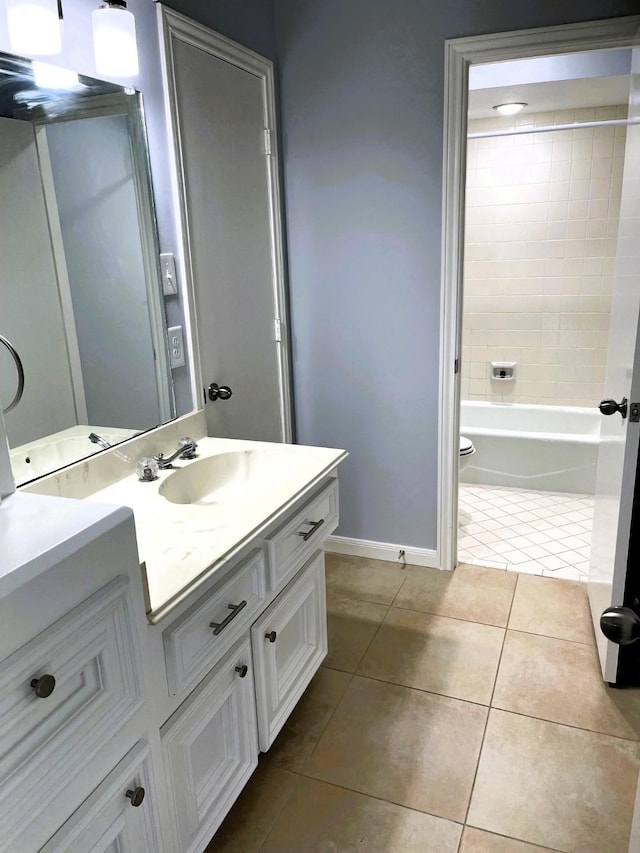 full bathroom with toilet, vanity, baseboards, shower / washtub combination, and tile patterned floors