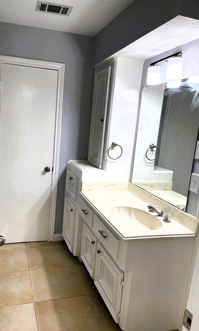 bathroom featuring tile patterned flooring, visible vents, and vanity