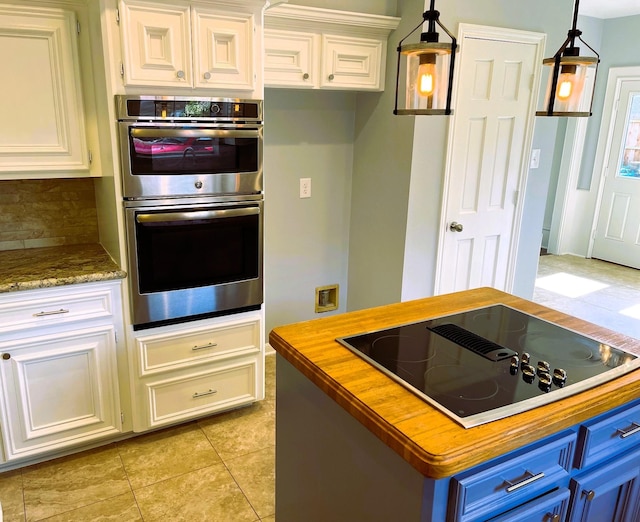 kitchen with double oven, wood counters, black electric cooktop, and white cabinets