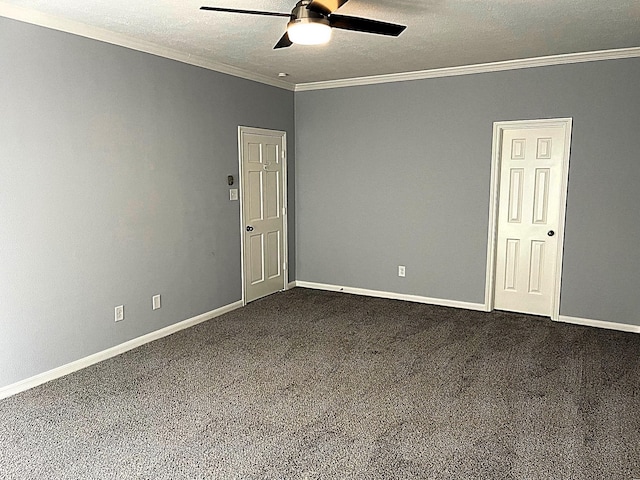 spare room with ceiling fan, a textured ceiling, baseboards, ornamental molding, and dark colored carpet