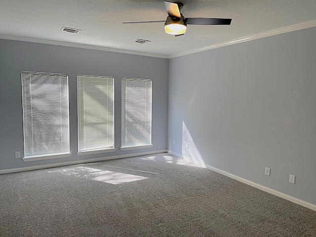 unfurnished room with carpet, visible vents, and crown molding