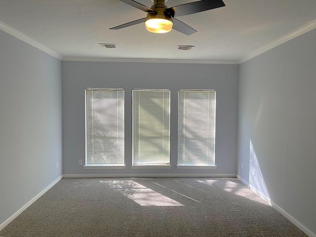 unfurnished room with ornamental molding, carpet, visible vents, and baseboards