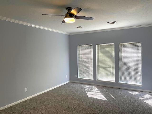 carpeted empty room with a textured ceiling, ornamental molding, visible vents, and baseboards