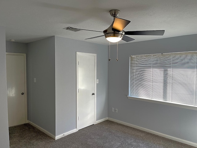 unfurnished bedroom featuring carpet, baseboards, and a textured ceiling