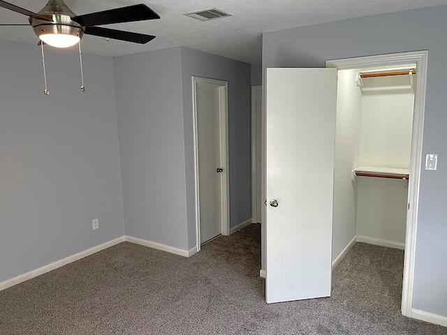 unfurnished bedroom with carpet floors, baseboards, visible vents, and a textured ceiling