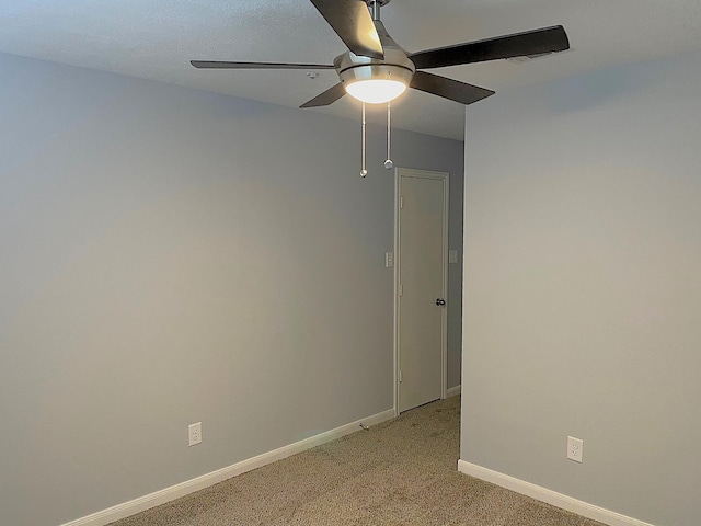 unfurnished room with light carpet, baseboards, and a ceiling fan