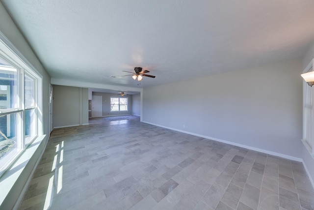 empty room featuring baseboards and a ceiling fan