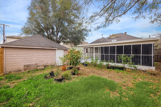 rear view of property featuring a sunroom