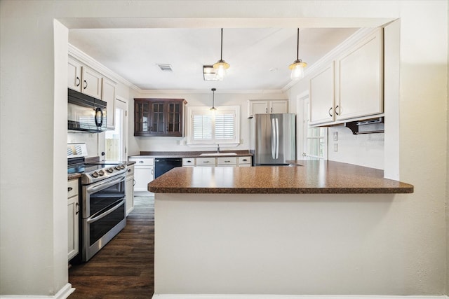 kitchen with a peninsula, black appliances, and white cabinets