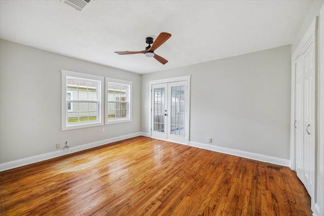 unfurnished bedroom featuring ceiling fan, visible vents, baseboards, french doors, and light wood-type flooring