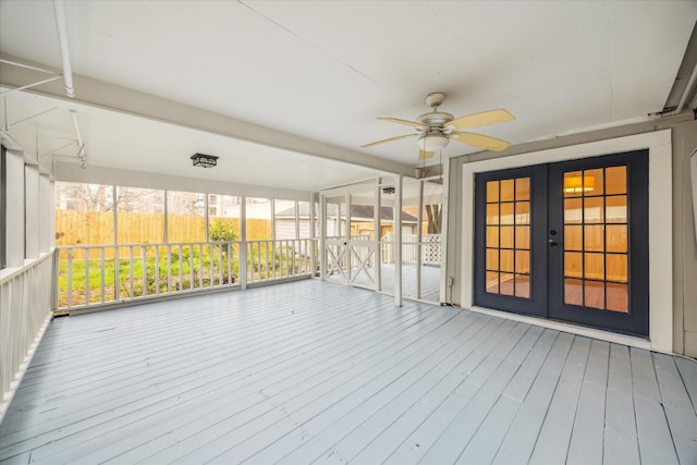 unfurnished sunroom with french doors and a ceiling fan