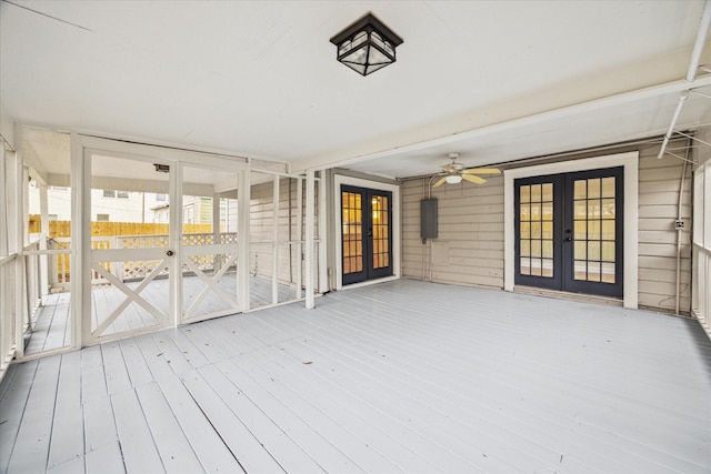 deck featuring ceiling fan, electric panel, and french doors