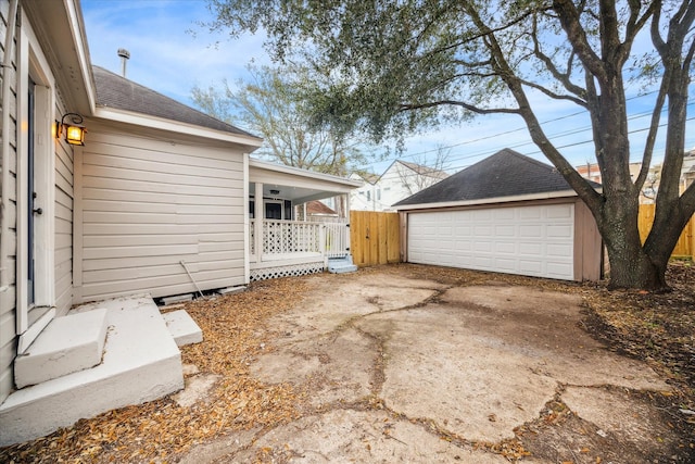 exterior space with a garage, fence, and an outdoor structure