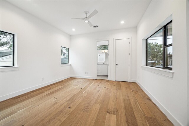 empty room featuring light wood-type flooring, baseboards, a ceiling fan, and recessed lighting