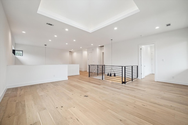 unfurnished room with light wood-style floors, baseboards, visible vents, and recessed lighting