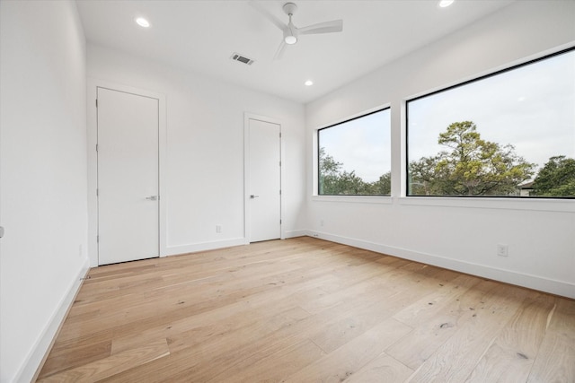 unfurnished bedroom featuring light wood-style flooring, visible vents, baseboards, and recessed lighting