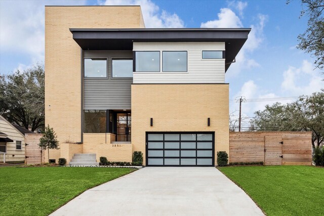 contemporary home with an attached garage, a front yard, concrete driveway, and brick siding