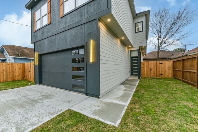 garage with driveway and fence