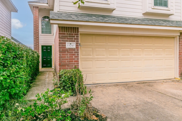 garage with concrete driveway